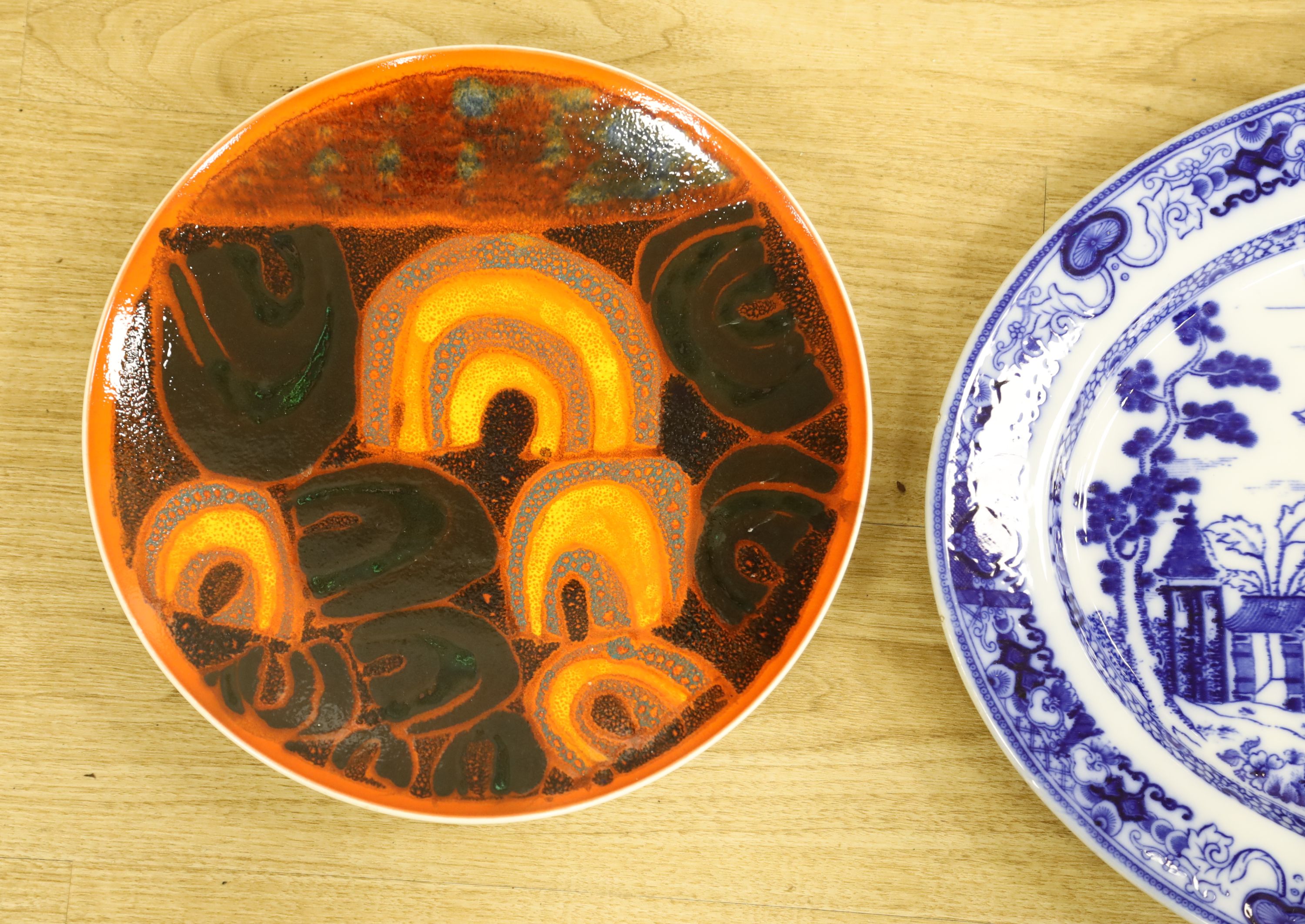 A Poole pottery charger and a blue and white oval Ashworth dish, length 55cm